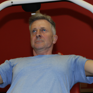 a professional appealing good looking and atheletic image of a caucasian man exercising in a gym