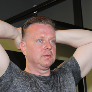 a professional appealing good looking and atheletic image of a caucasian man exercising in a gym