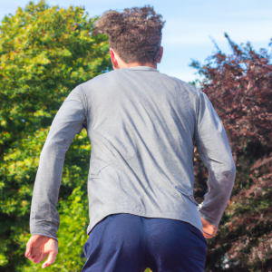 a professional appealing good looking and atheletic image of a caucasian man exercising or playing sports outside on a sunny day