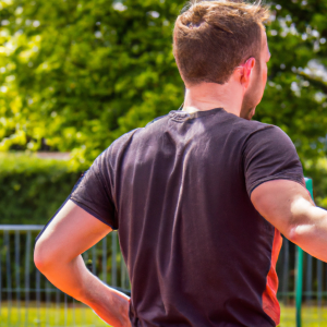 a professional appealing good looking and atheletic image of a caucasian man exercising or playing sports outside on a sunny day