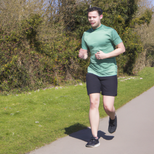 a professional appealing image of a caucasian man or woman jogging on a sunny day